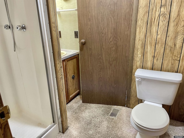 bathroom featuring vanity, a shower, and toilet