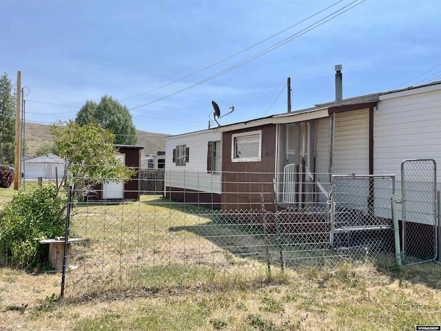 rear view of property with a lawn