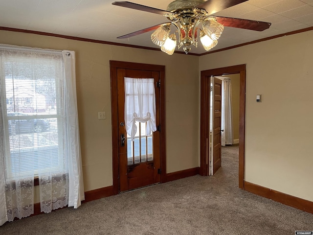 interior space with crown molding, carpet floors, and ceiling fan