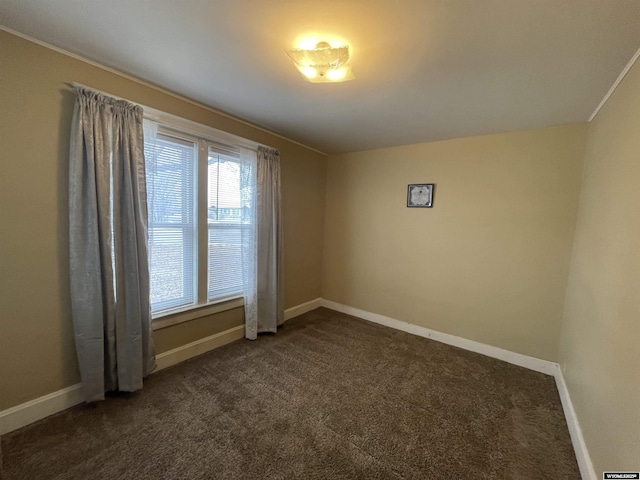 empty room with dark colored carpet