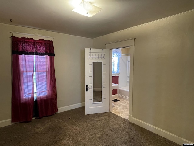 unfurnished bedroom featuring multiple windows and carpet