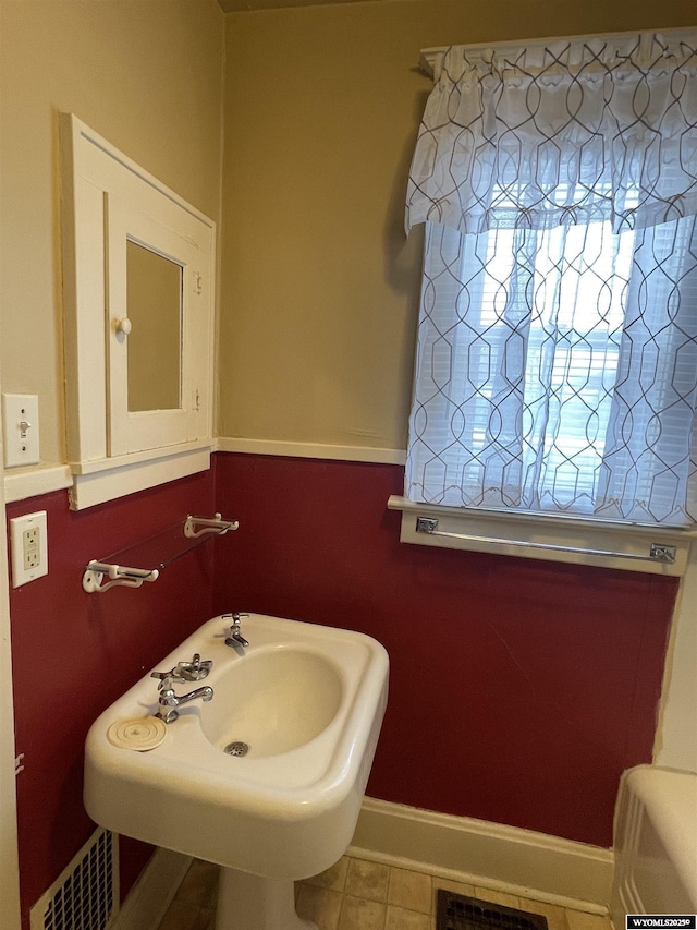 bathroom featuring tile patterned flooring and sink