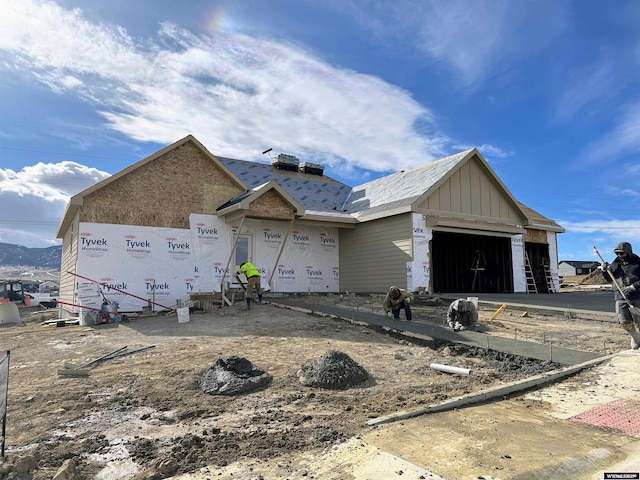 unfinished property featuring board and batten siding and an attached garage