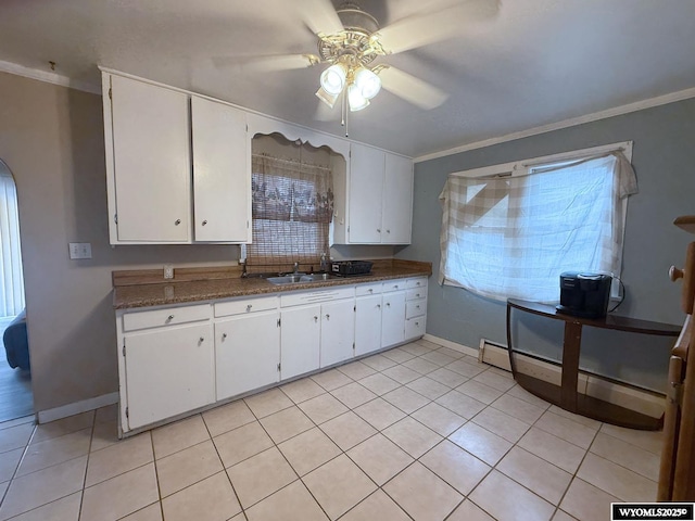 kitchen featuring white cabinetry, sink, crown molding, and baseboard heating