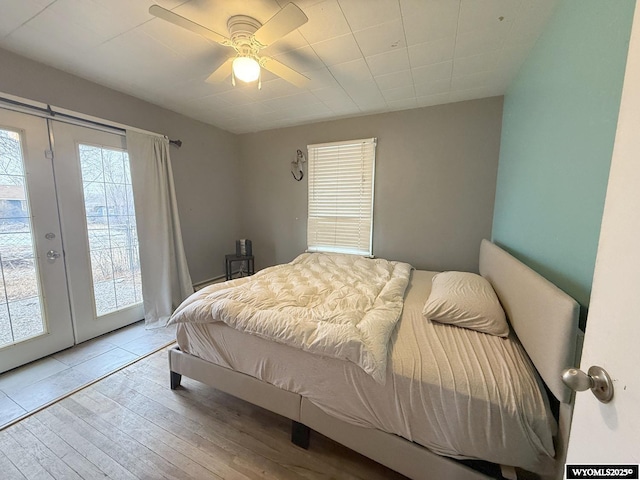 bedroom featuring french doors, ceiling fan, light wood-type flooring, and access to outside