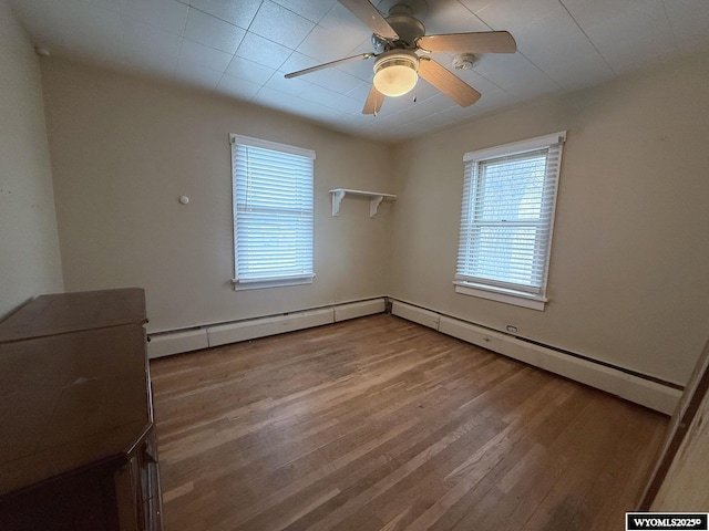 unfurnished room with hardwood / wood-style floors and ceiling fan