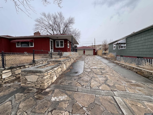 rear view of house featuring a garage and an outdoor structure