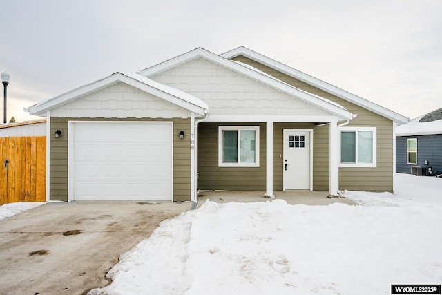 view of front of home with a garage and cooling unit