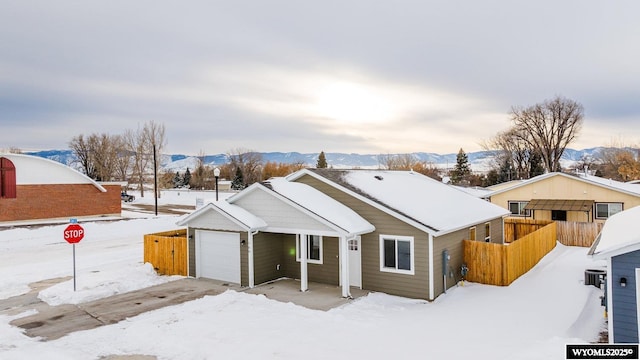 ranch-style home featuring a mountain view and a garage