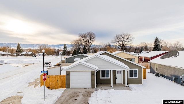 view of front of property featuring a mountain view and a garage