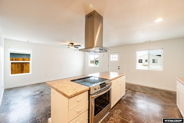 kitchen featuring a center island, island range hood, ceiling fan, and stainless steel electric range