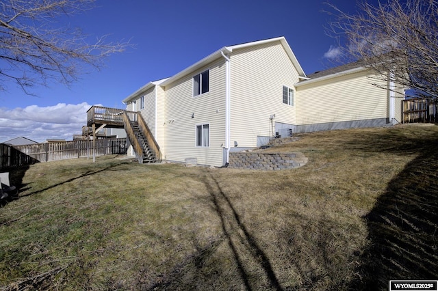 back of house with a wooden deck, a yard, and central AC unit