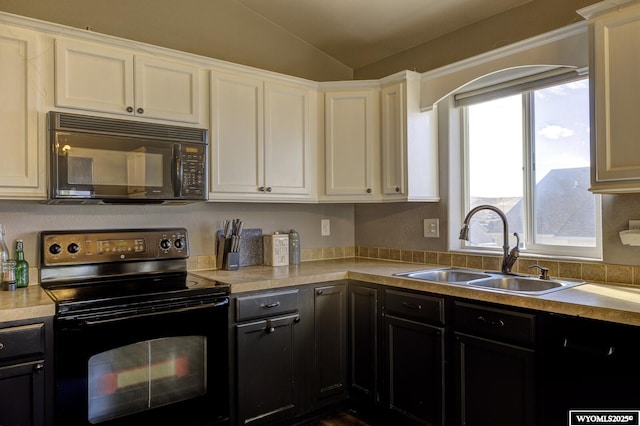 kitchen with white cabinetry, vaulted ceiling, sink, and black appliances