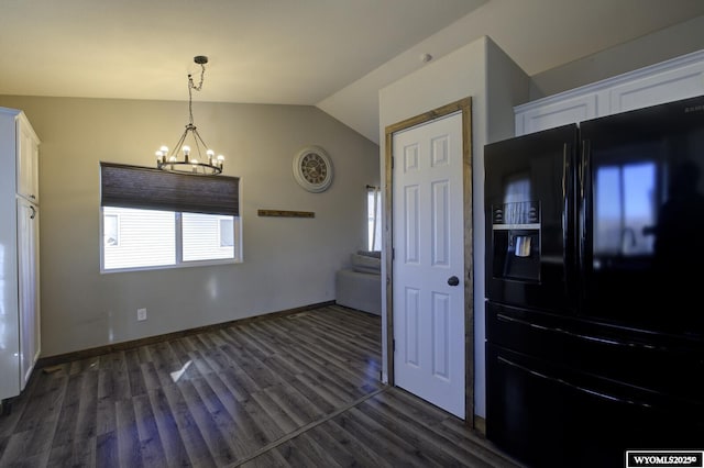 kitchen with white cabinetry, hanging light fixtures, black refrigerator with ice dispenser, and an inviting chandelier