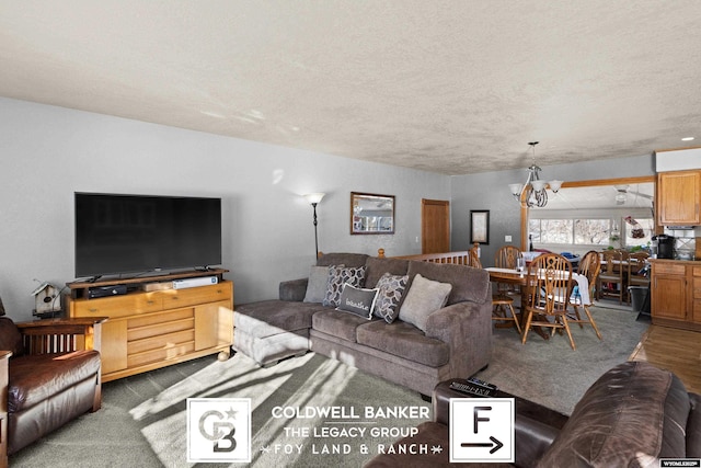 living room with a textured ceiling and a chandelier