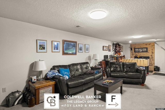 carpeted living room featuring a textured ceiling