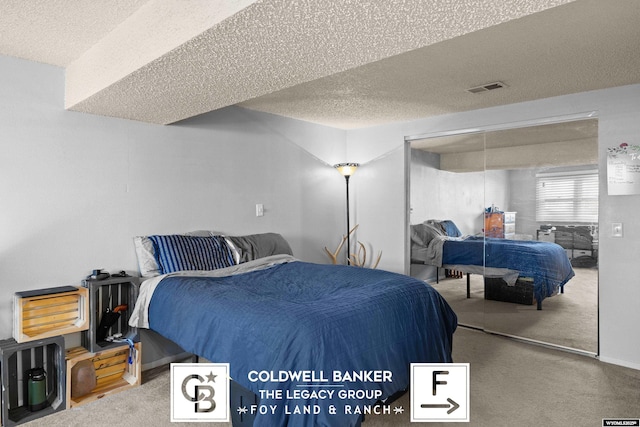 bedroom with carpet, a textured ceiling, and a closet