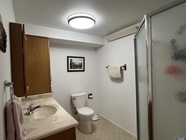 bathroom featuring tile patterned floors, toilet, a shower with shower door, a textured ceiling, and vanity