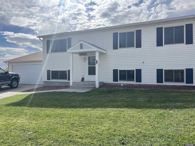 raised ranch with a garage and a front yard