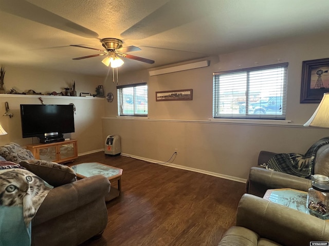 living room with ceiling fan, a textured ceiling, and dark hardwood / wood-style flooring