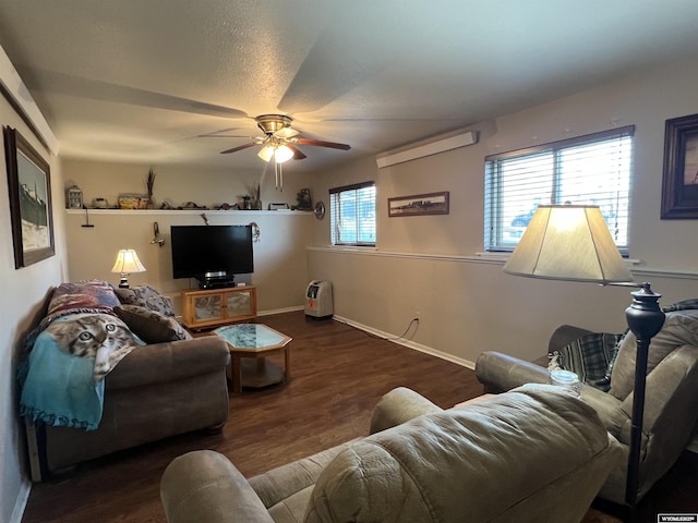 living room featuring ceiling fan and dark hardwood / wood-style flooring