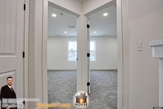 corridor featuring carpet floors, recessed lighting, visible vents, and baseboards