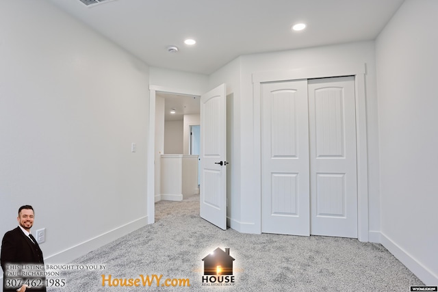 unfurnished bedroom with light carpet, baseboards, and recessed lighting