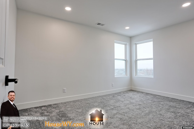 spare room featuring recessed lighting, carpet flooring, visible vents, and baseboards