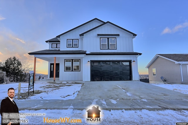 view of front of house with board and batten siding, covered porch, an attached garage, and concrete driveway