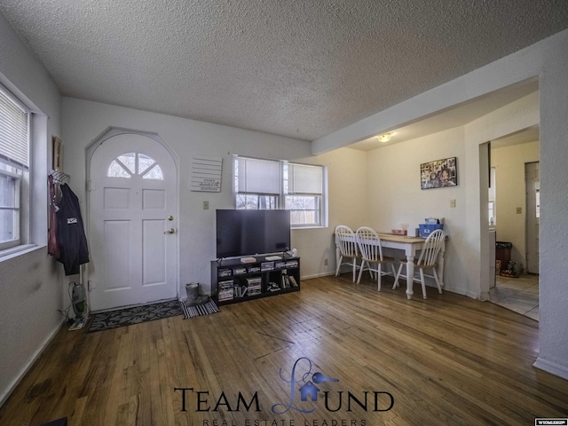 entryway featuring hardwood / wood-style floors and a textured ceiling