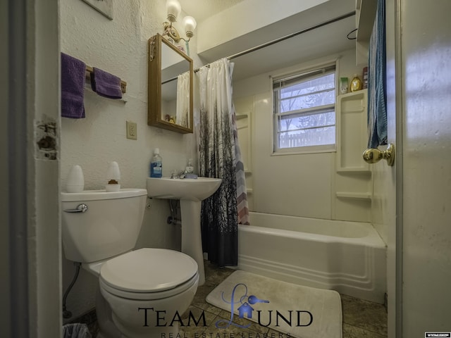 bathroom with toilet and shower / bath combo with shower curtain