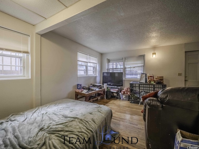 bedroom featuring hardwood / wood-style floors and a textured ceiling