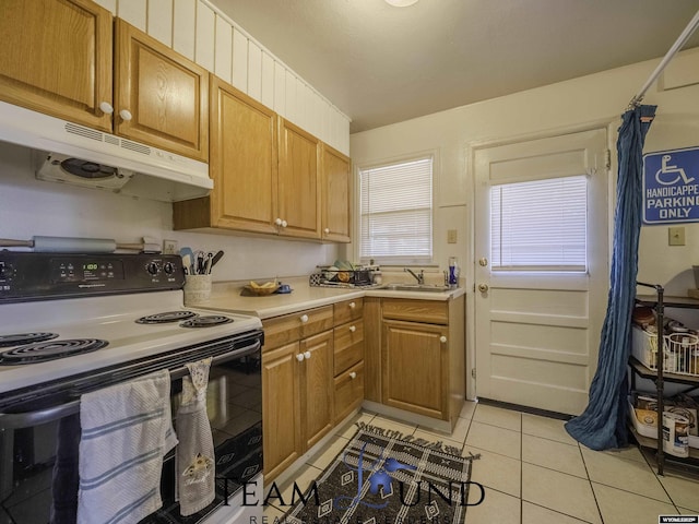 kitchen featuring range with electric cooktop, sink, and light tile patterned floors