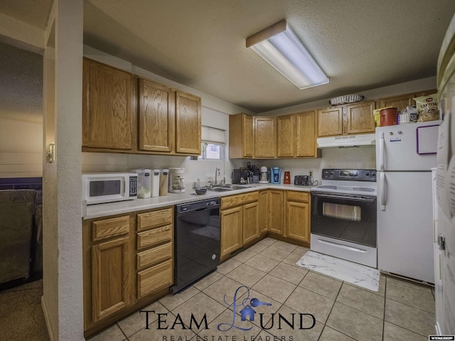 kitchen with sink, light tile patterned floors, a textured ceiling, and white appliances