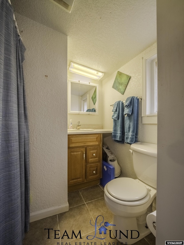 bathroom with tile patterned floors, toilet, and vanity