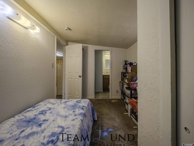 carpeted bedroom featuring a textured ceiling