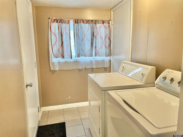 laundry area featuring washer and dryer and light tile patterned flooring