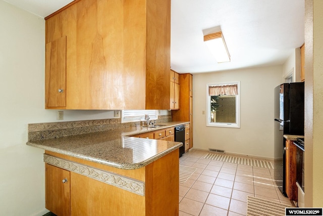 kitchen with light tile patterned floors, black appliances, sink, and kitchen peninsula