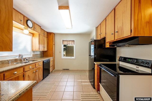 kitchen featuring light tile patterned floors, plenty of natural light, sink, and black appliances