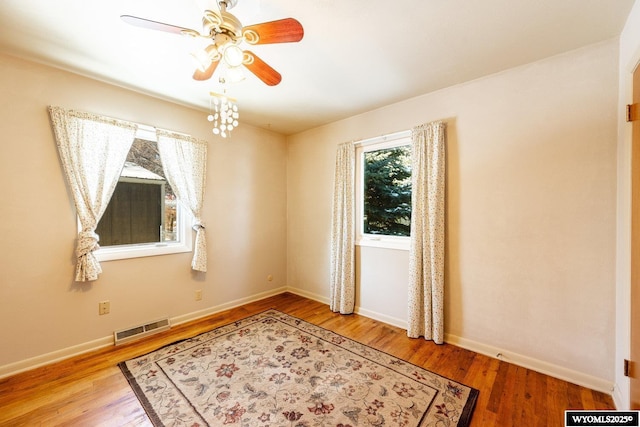 unfurnished room with ceiling fan and wood-type flooring