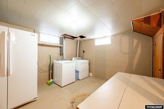 laundry area featuring plenty of natural light and separate washer and dryer