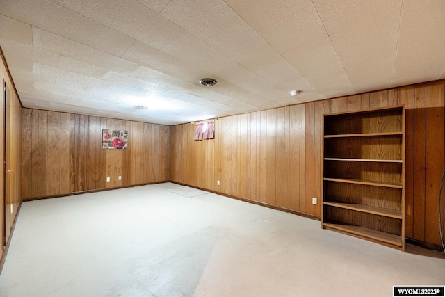 basement featuring wood walls