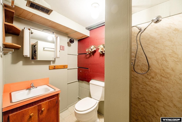 bathroom featuring vanity, toilet, and walk in shower