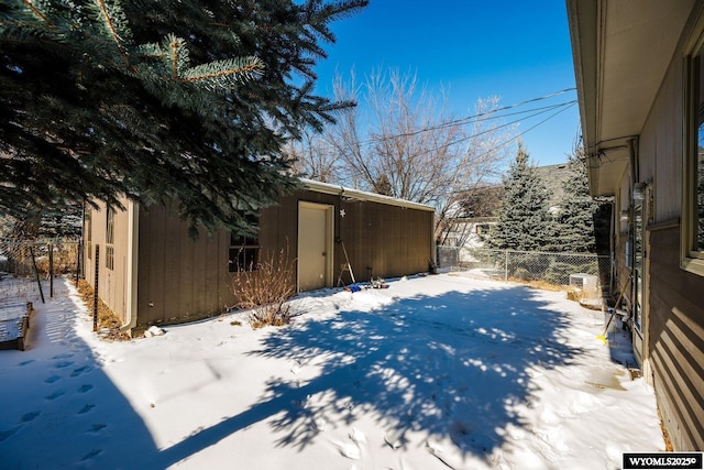 yard covered in snow featuring an outdoor structure