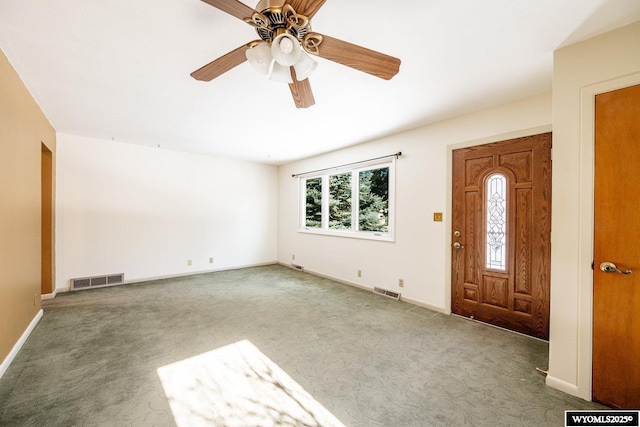 foyer entrance featuring light carpet and ceiling fan