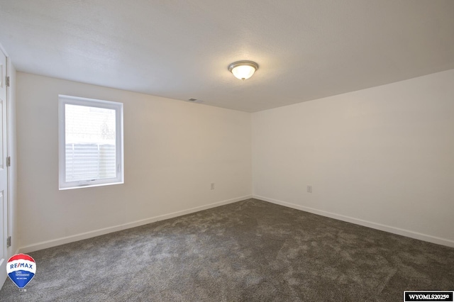 empty room with dark carpet