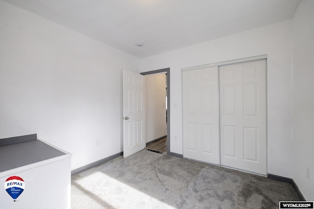 unfurnished bedroom featuring a closet and carpet