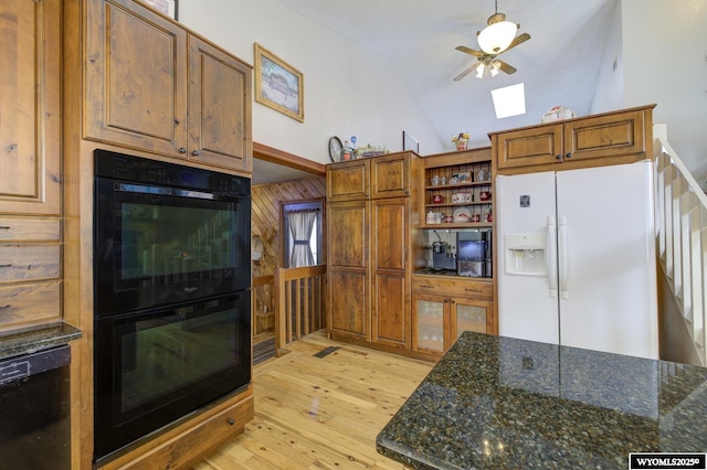 kitchen featuring open shelves, lofted ceiling, light wood-style flooring, brown cabinetry, and black appliances