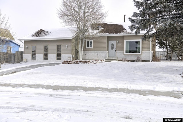 ranch-style home with fence and brick siding