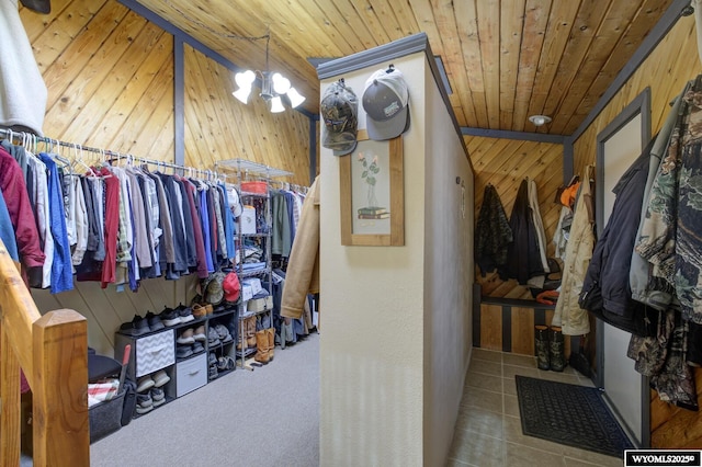 walk in closet with a chandelier and carpet floors